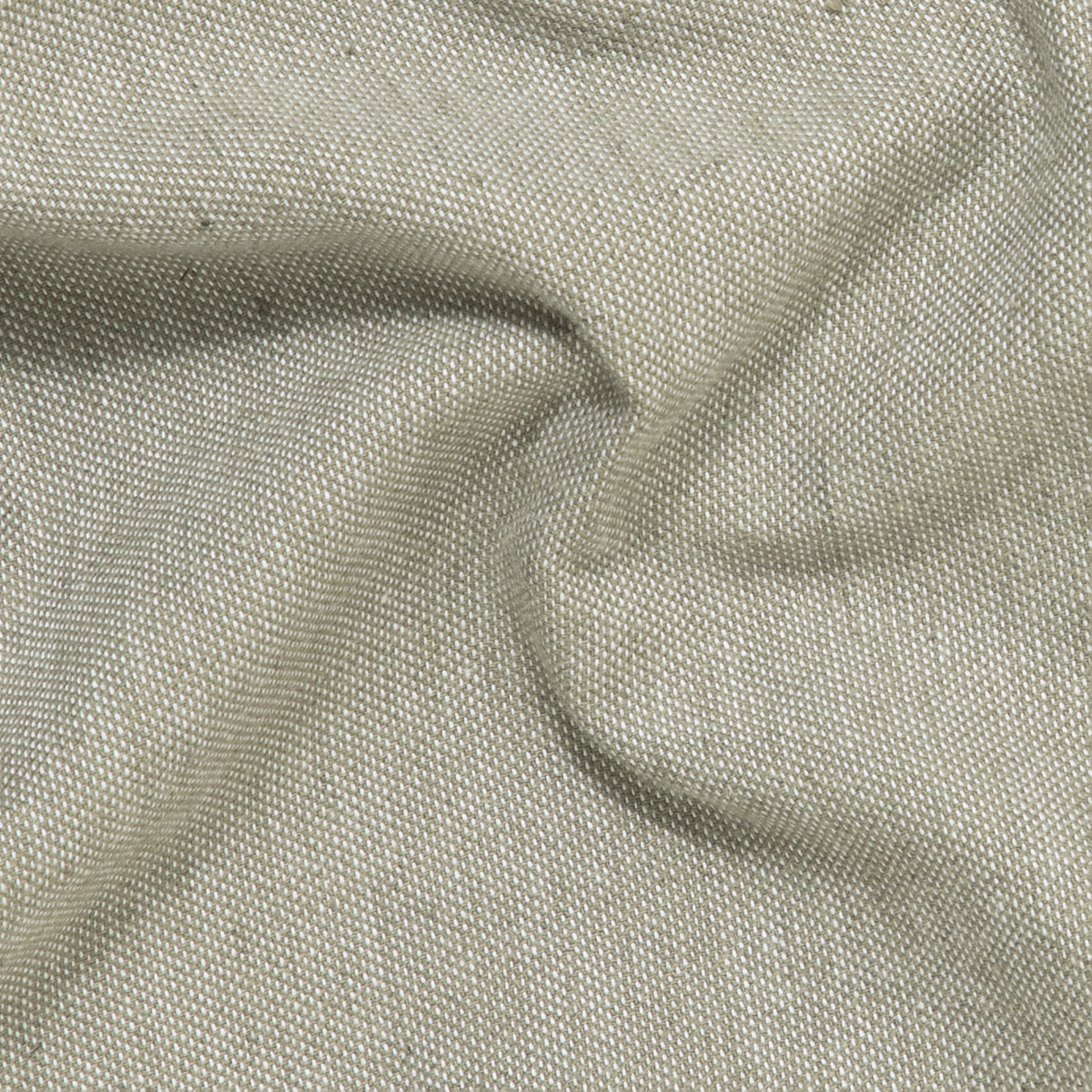 A close-up of beige European linen from the Stretch Linen Short shows visible texture and subtle folds, creating gentle shadows and highlights across the fabric surface.