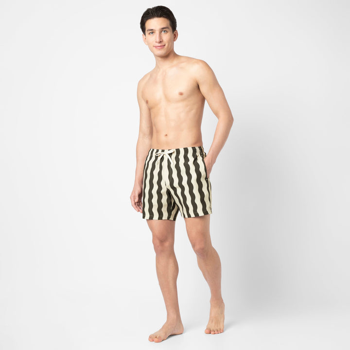 Full body view of a model wearing the Stretch Swim Trunk (Clearance) in Orca Wavy Stripe, 5.5" inseam.