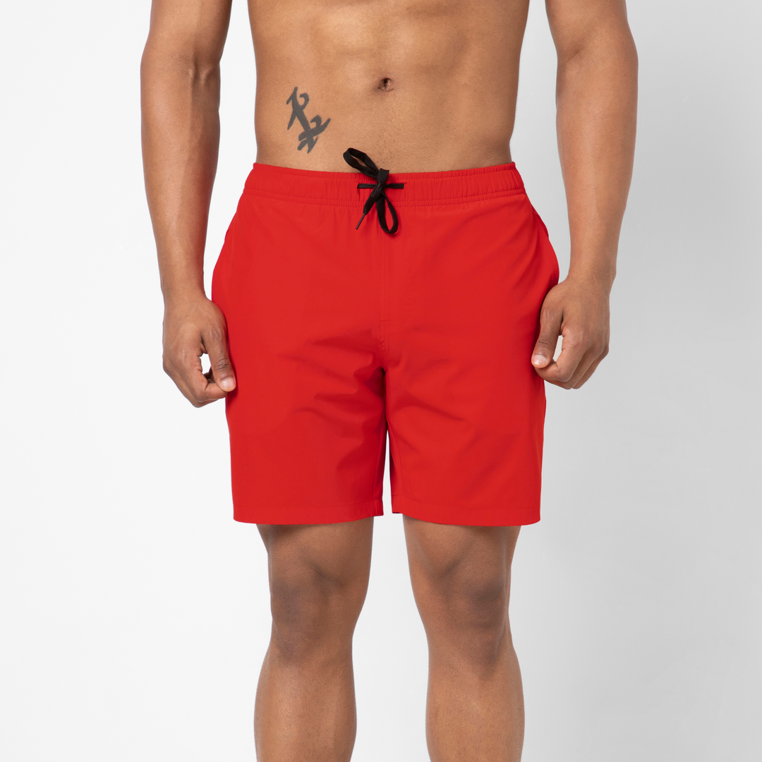 Stretch Swim Trunk (Clearance) in solid Red, 7" inseam, shown front facing on a model against a plain white background.