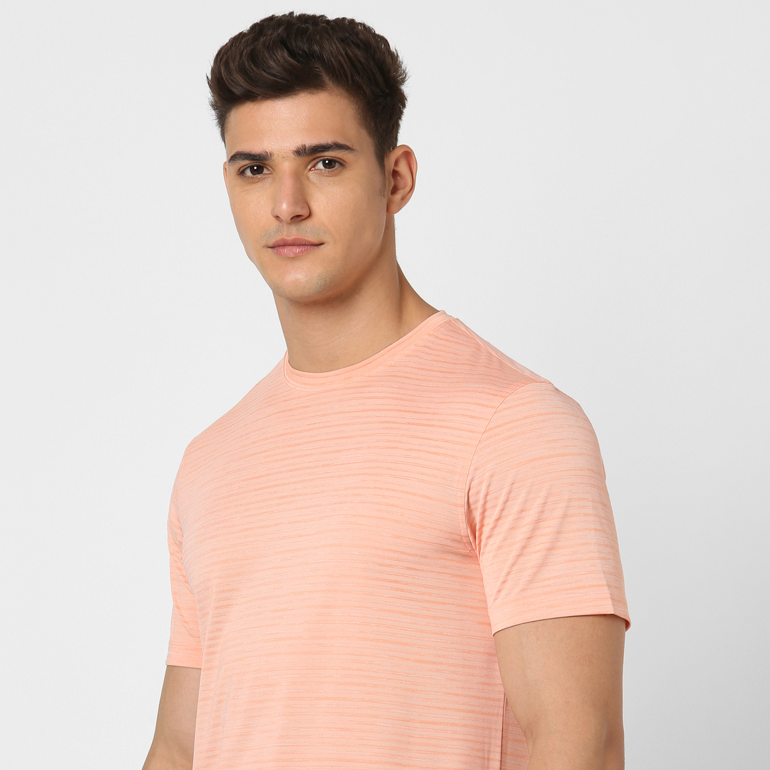 Stride Tee Coral close up on model