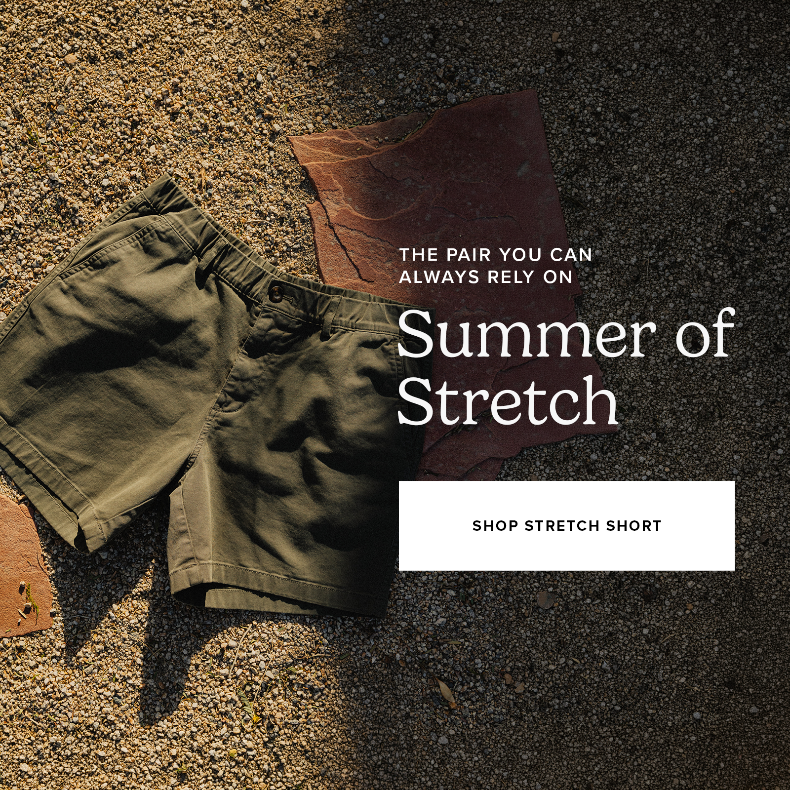 Stretch Short in Crocodile laying on a pebble background