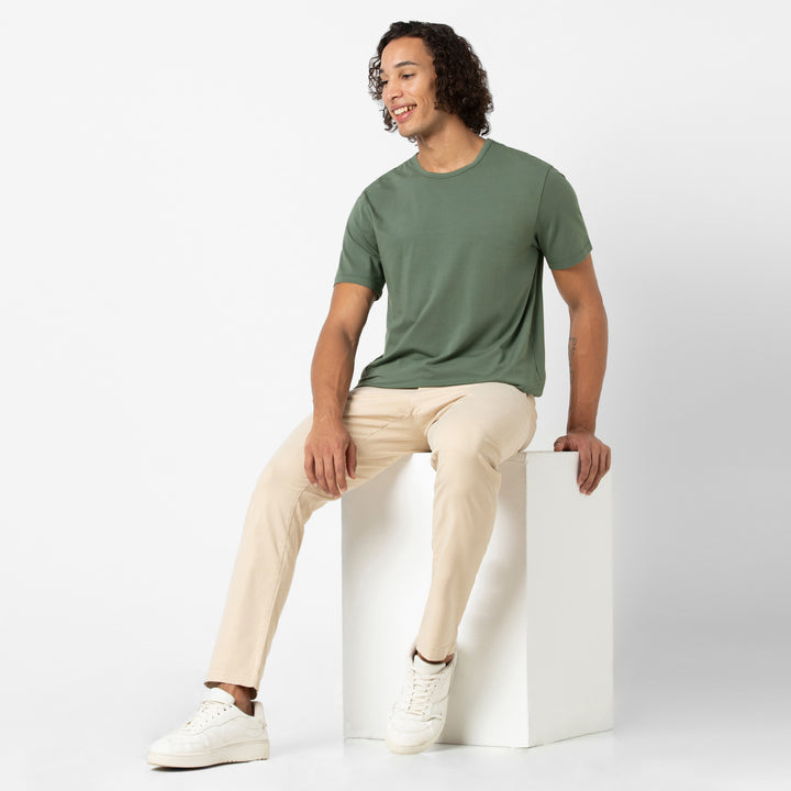 Supima Curved Tee Dark Sage full body on model with Stretch Chino Pant Sand Dune