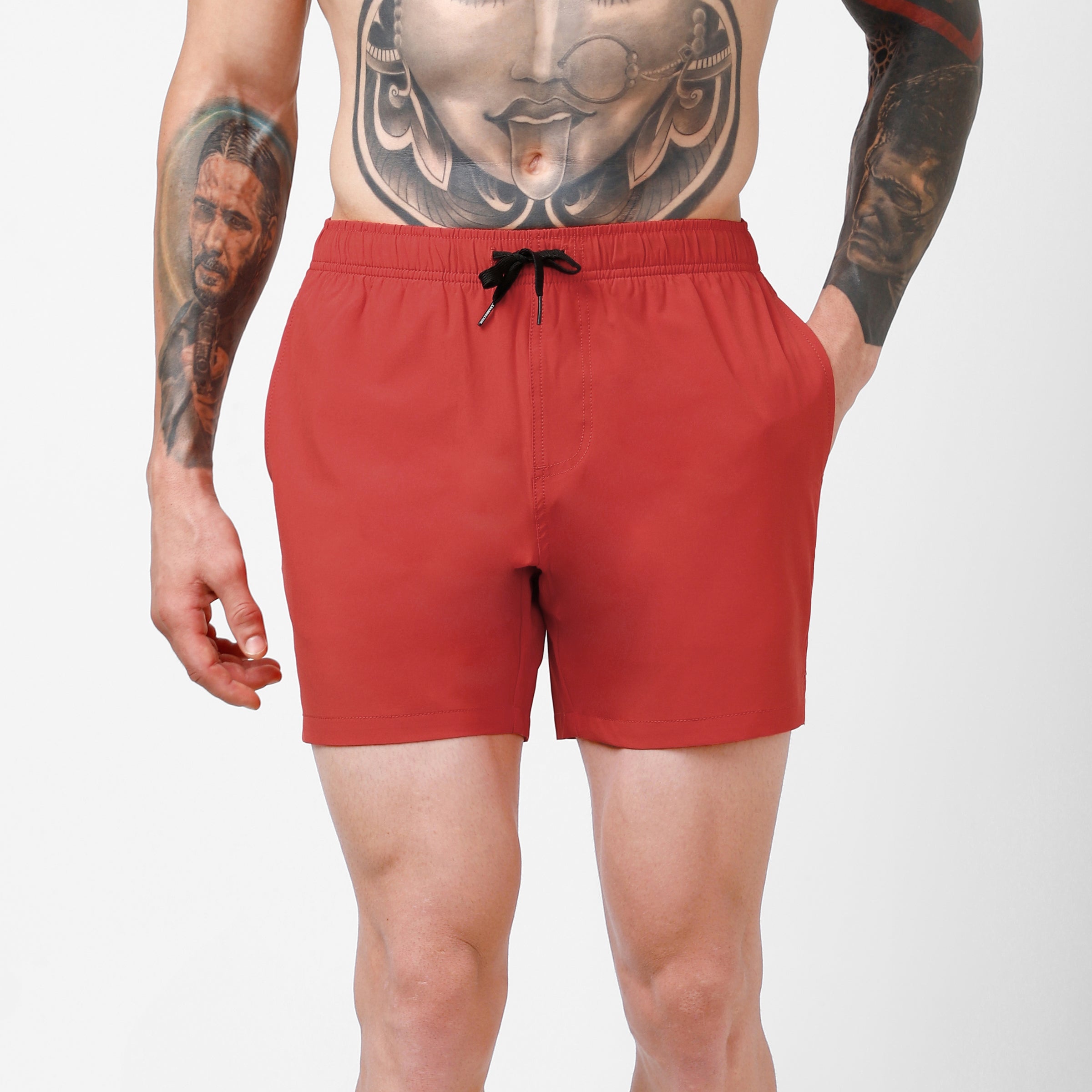 Stretch Swim 5.5" in Red front on model hand in side seam pocket