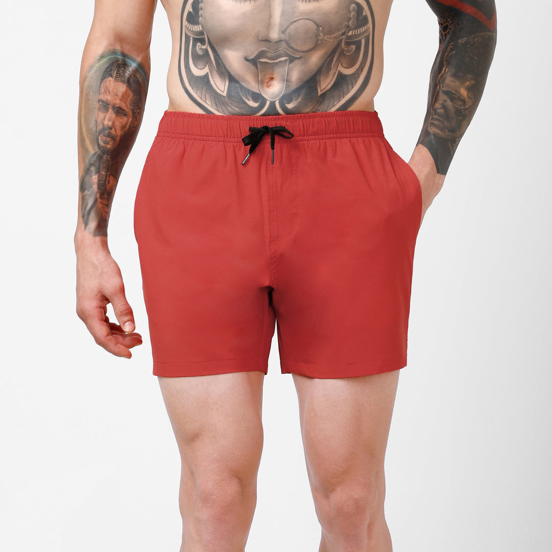 Stretch Swim 5.5" in Red front on model hand in side seam pocket