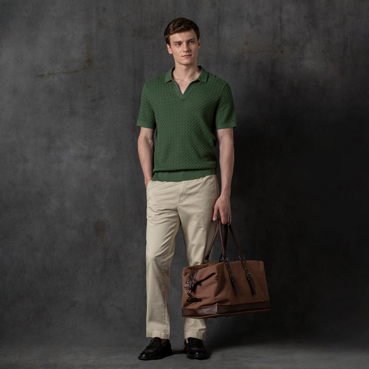 Textured Knit Sweater Polo Alphine Charcoal Backdrop full body on model with travel duffle