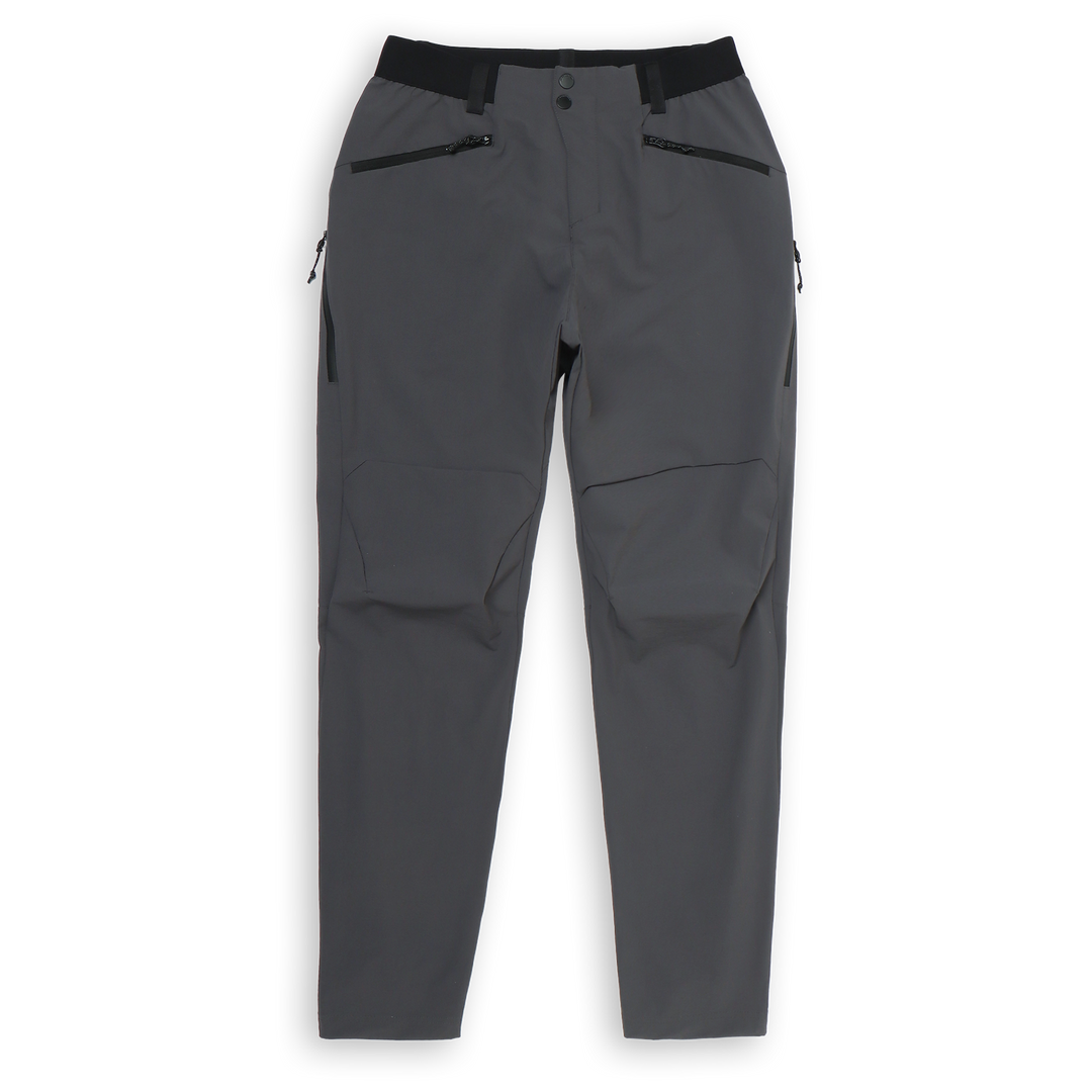 Trail Pant Coal front with zipper front pockets, elastic waistband with belt loop, and perforated side vent pockets.