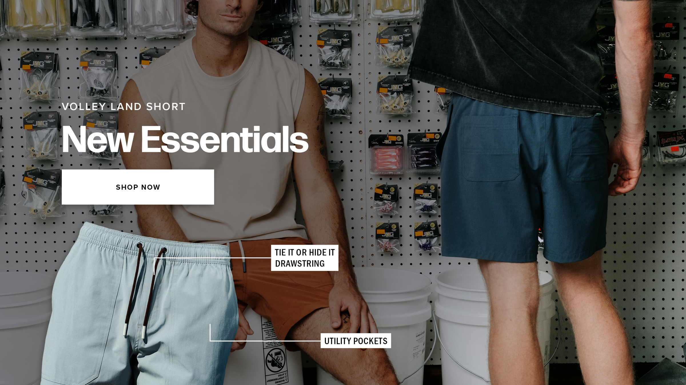 A promotional collage for Volley Land Short New Essentials showing three models wearing different styles of Volley Land shorts. The background shows a retail pegboard with various fishing accessories.