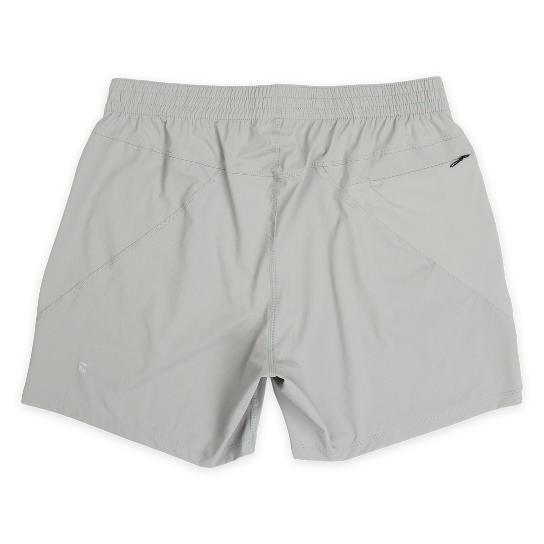 Atlas Short 5.5" Grey back with elastic waistband, back right zippered pocket, and small reflective logo of Bear drawn inside the letter B in bottom left corner