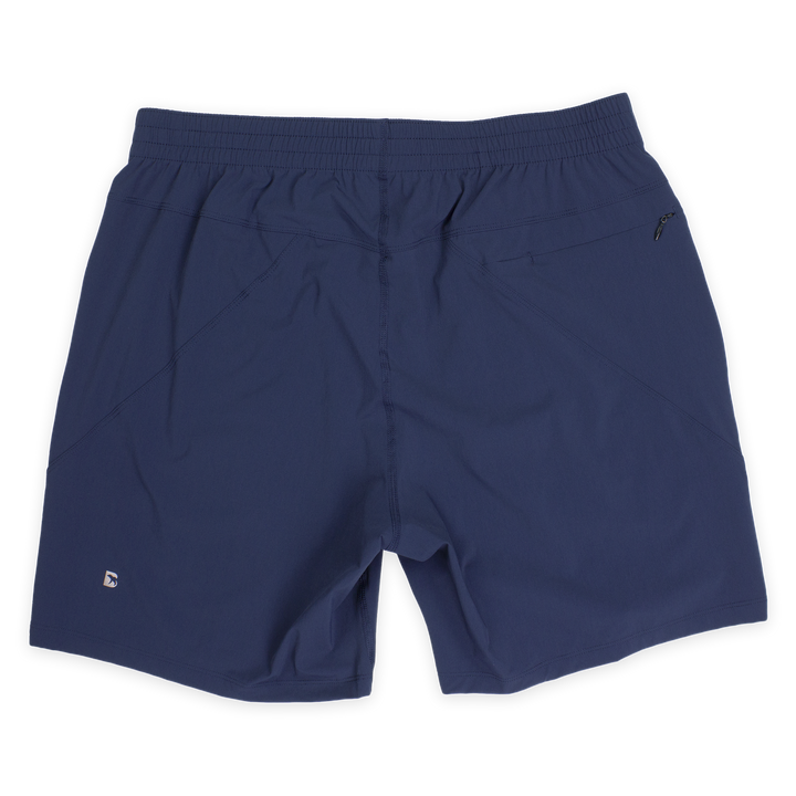 Atlas Short 7" Navy Back with elastic waistband, back right zippered pocket, and small reflective logo of Bear drawn inside the letter B in bottom left corner