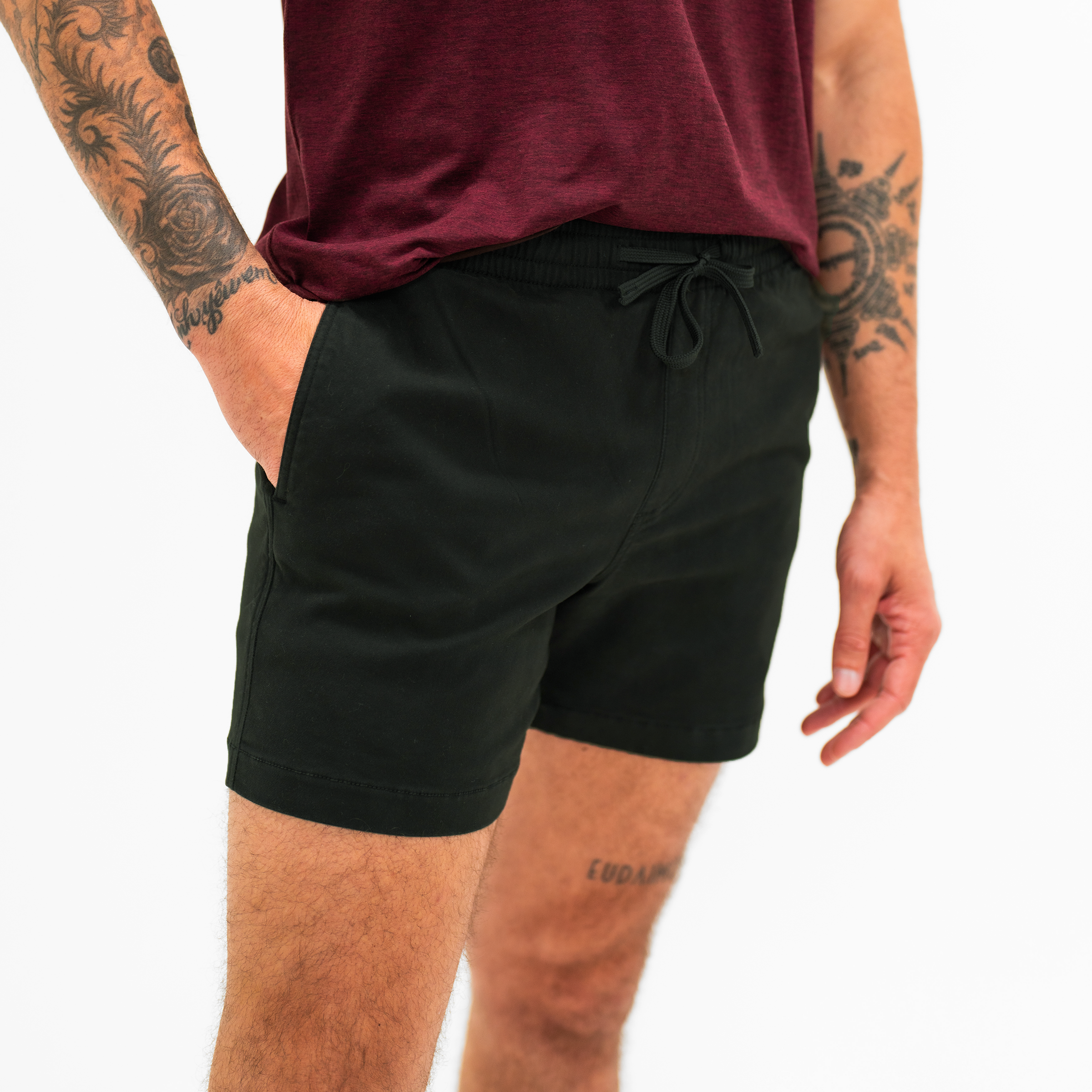 Alto Short 5.5" inseam in Black side on modelwith elastic waistband, fabric drawstring, faux fly, and two front side seam pockets