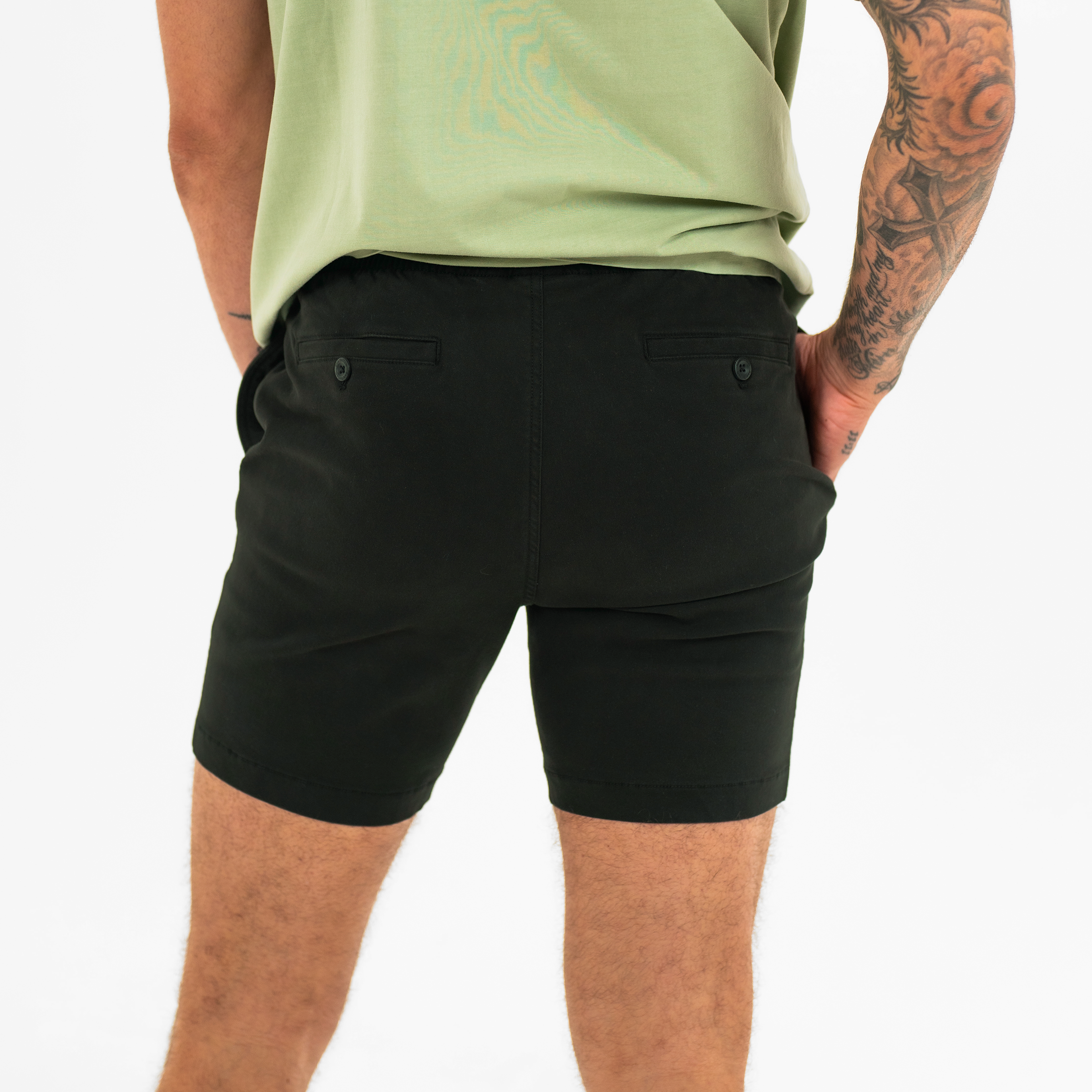 Alto Short 7" inseam in Black back on model with elastic waistband and two welt pocket with horn buttons