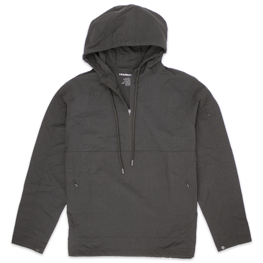Windbreaker Jacket in Graphite grey with kangaroo pocket with zippers, zipper stash pocket on right arm, wrist snaps for secure fit, rubberized hood drawstring, and three-quarter zipper through collar