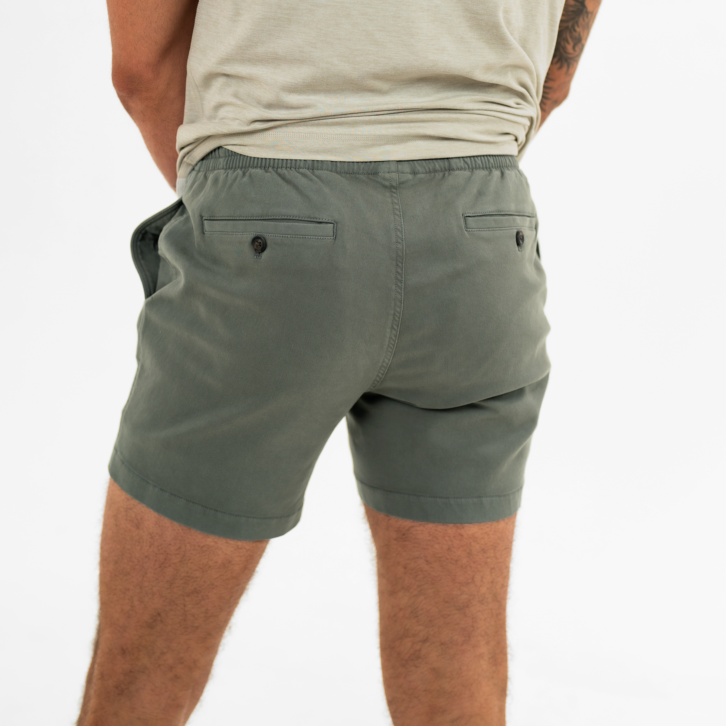 Alto Short 5.5" inseam in Grey back on model with elastic waistband and two welt pocket with horn buttons
