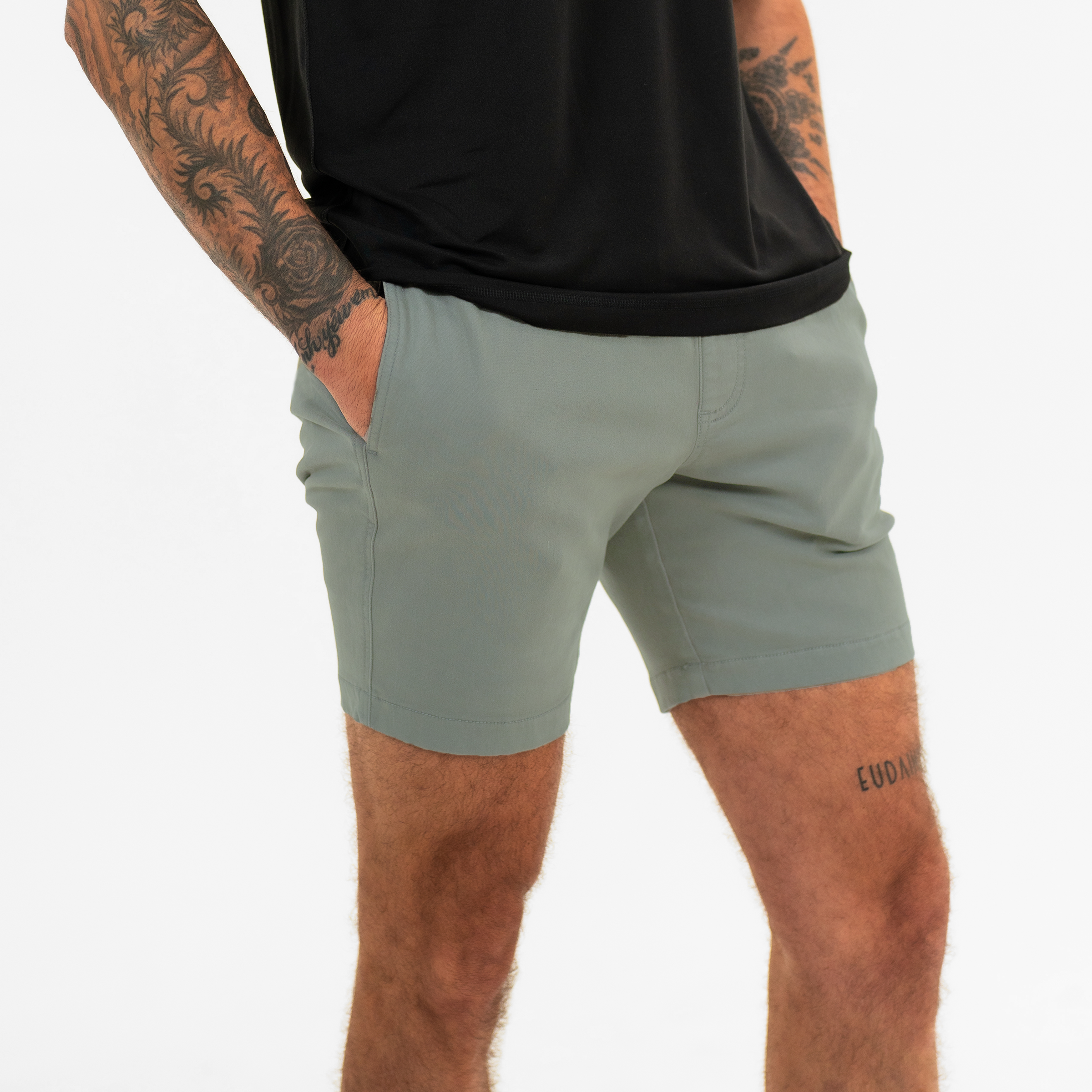Alto Short 7" inseam in Grey side on model  with elastic waistband, fabric drawstring, faux fly, and two front side seam pockets