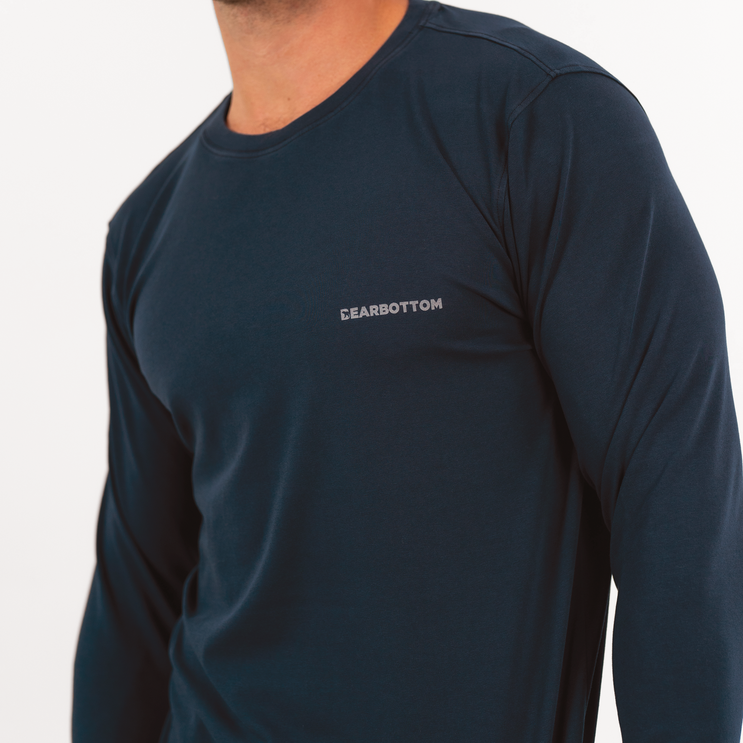 Natural Dye Logo Long Sleeve Tee in Navy blue close up on model of Bearbottom logo on left chest