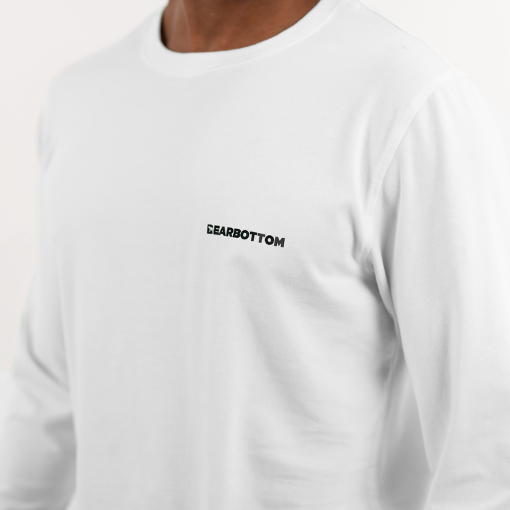 Natural Dye Logo Long Sleeve Tee in White close up on model of Bearbottom logo on front left chest