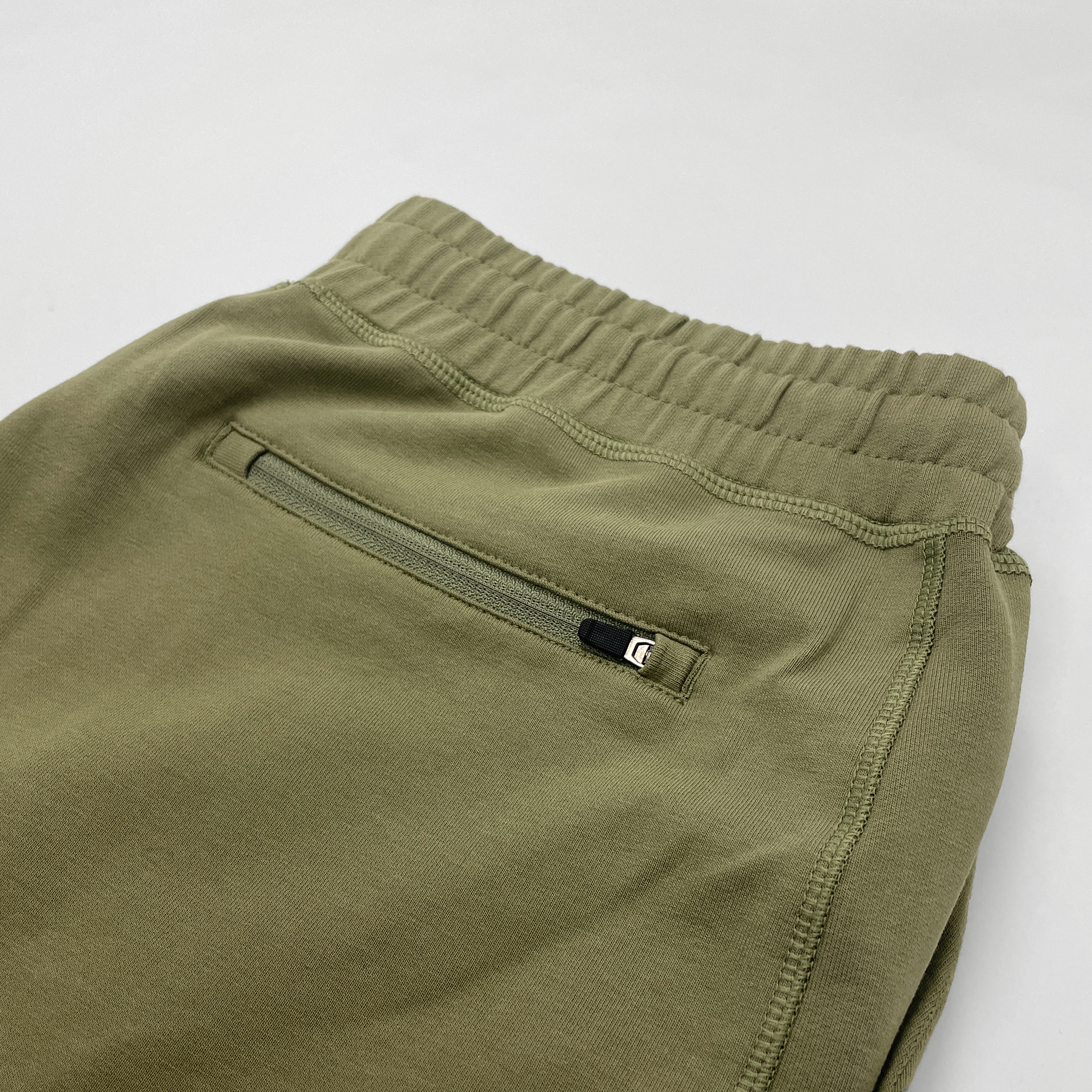 Loft Jogger Olive folded showing back right zipper pocket