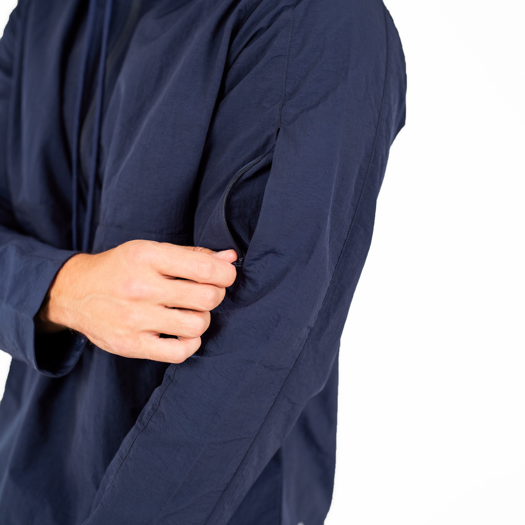 Windbreaker Jacket in Navy blue close up of zipper pocket on upper arm