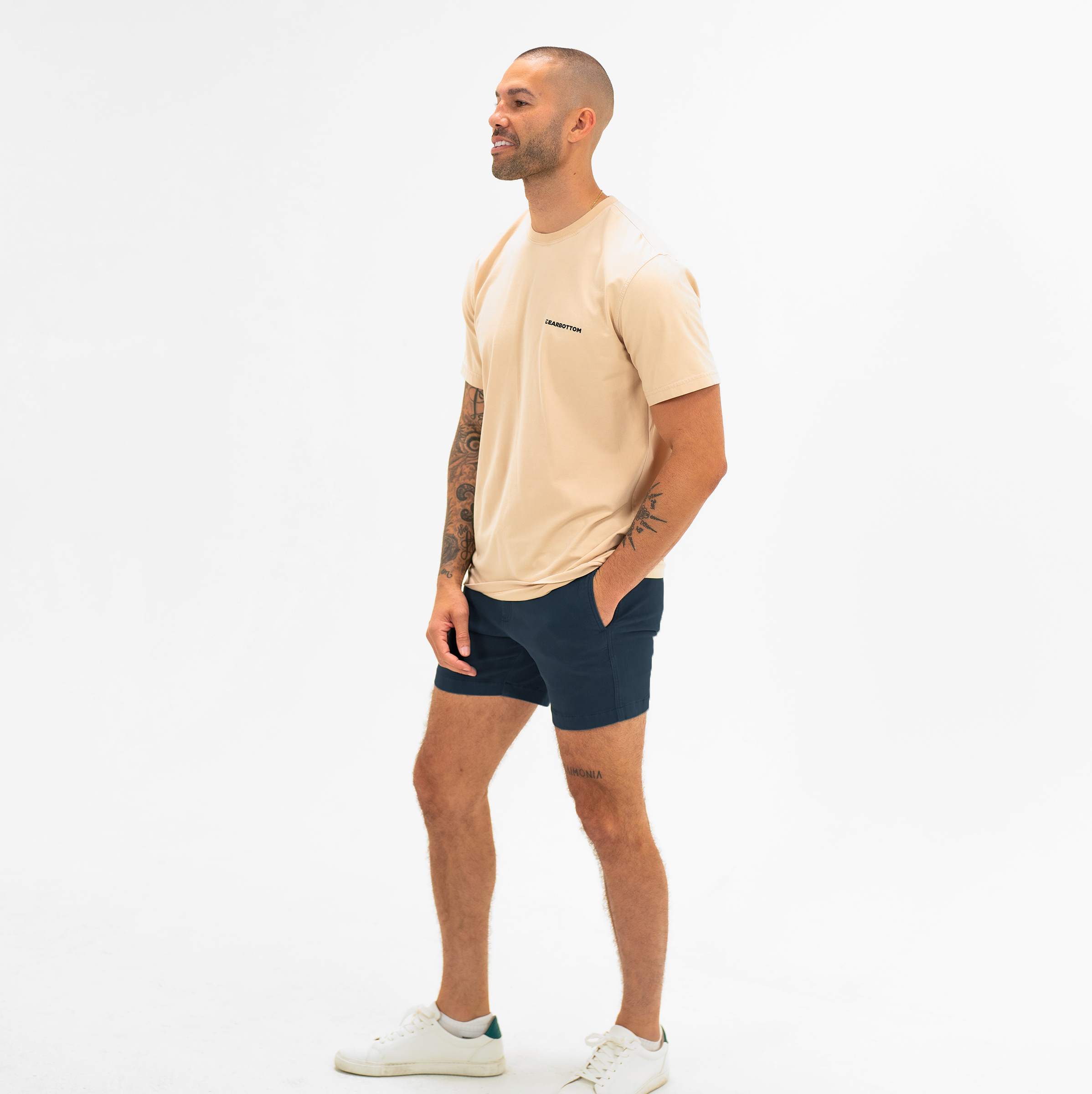 Alto Short 5.5" inseam in Navy side on model worn with Natural Dye Logo Tee in Sand