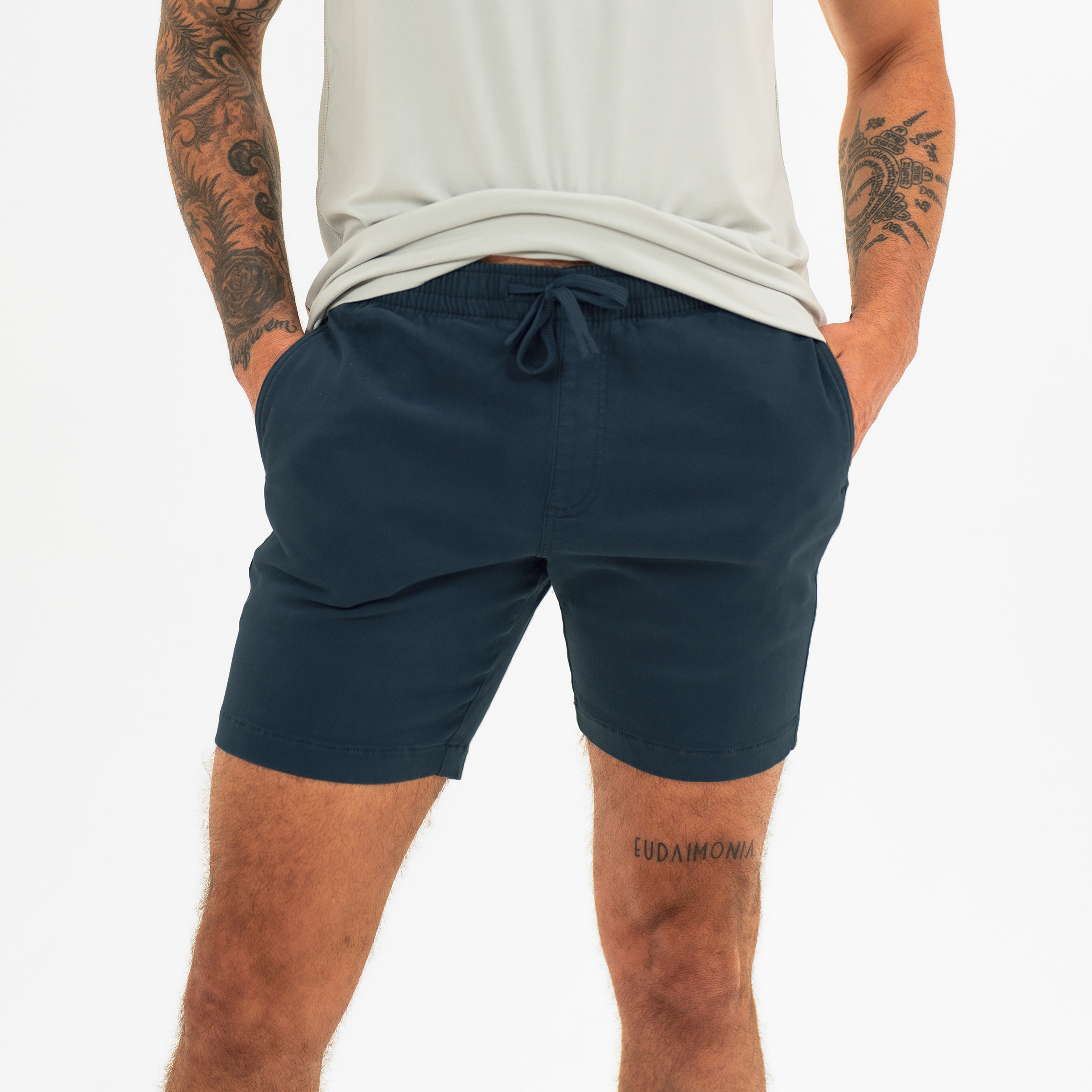 Alto Short 7" inseam in Navy front on model with elastic waistband, fabric drawstring, faux fly, and two front side seam pockets