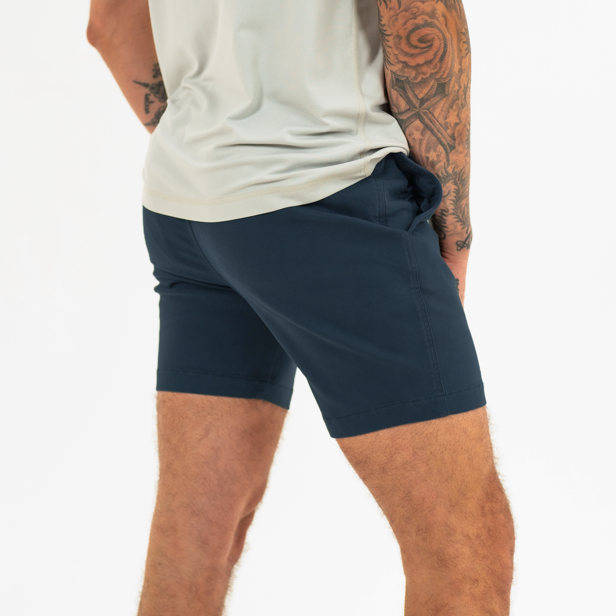 Alto Short 7" inseam in Navy back on model with elastic waistband and two welt pocket with horn buttons