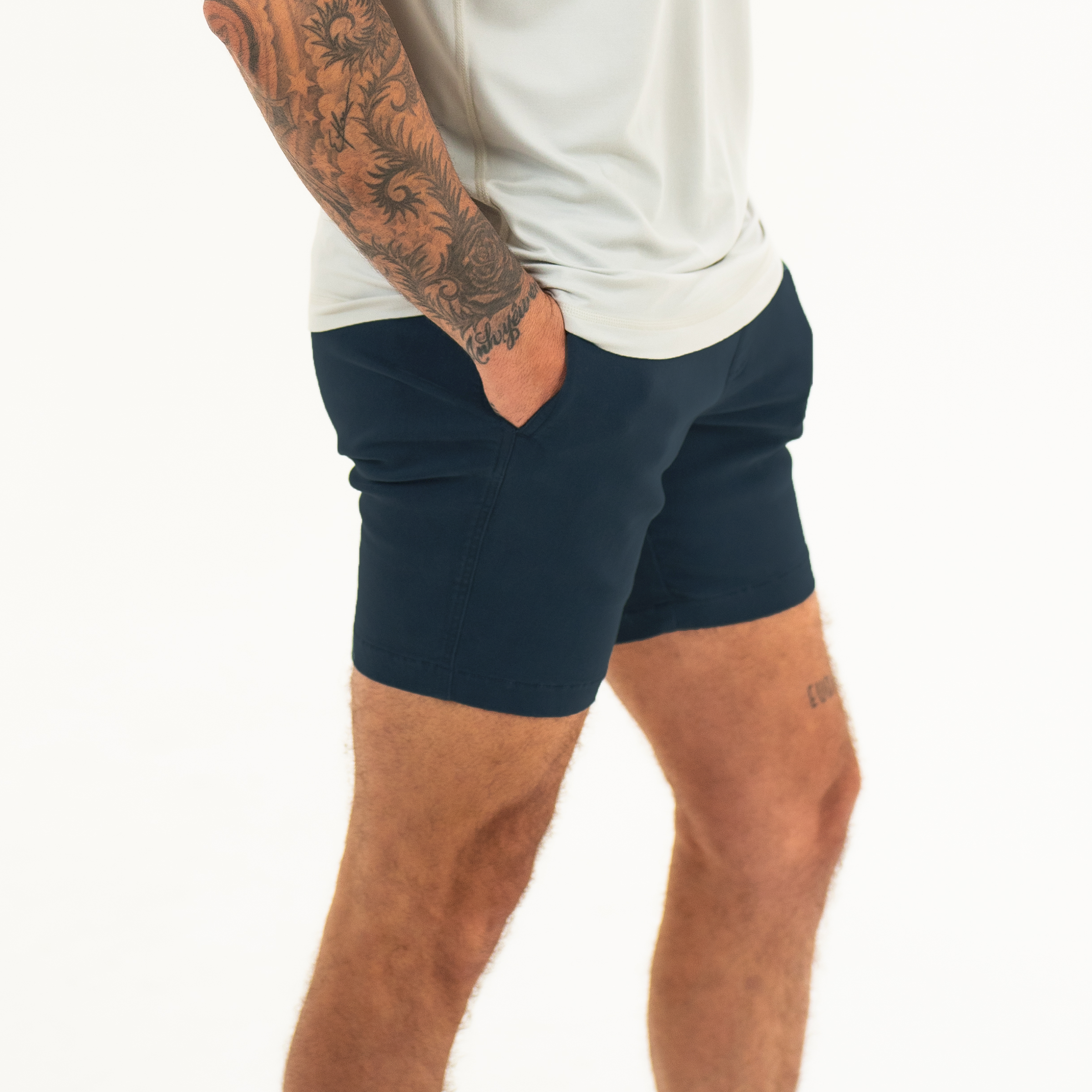 Alto Short 7" inseam in Navy side on model with elastic waistband, fabric drawstring, faux fly, and two front side seam pockets