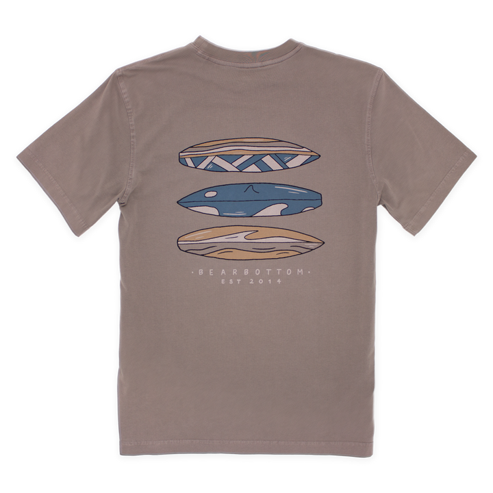 Back of Natural Dye Graphic Tee Riptide with graphic of 3 blue white and yellow surfboards