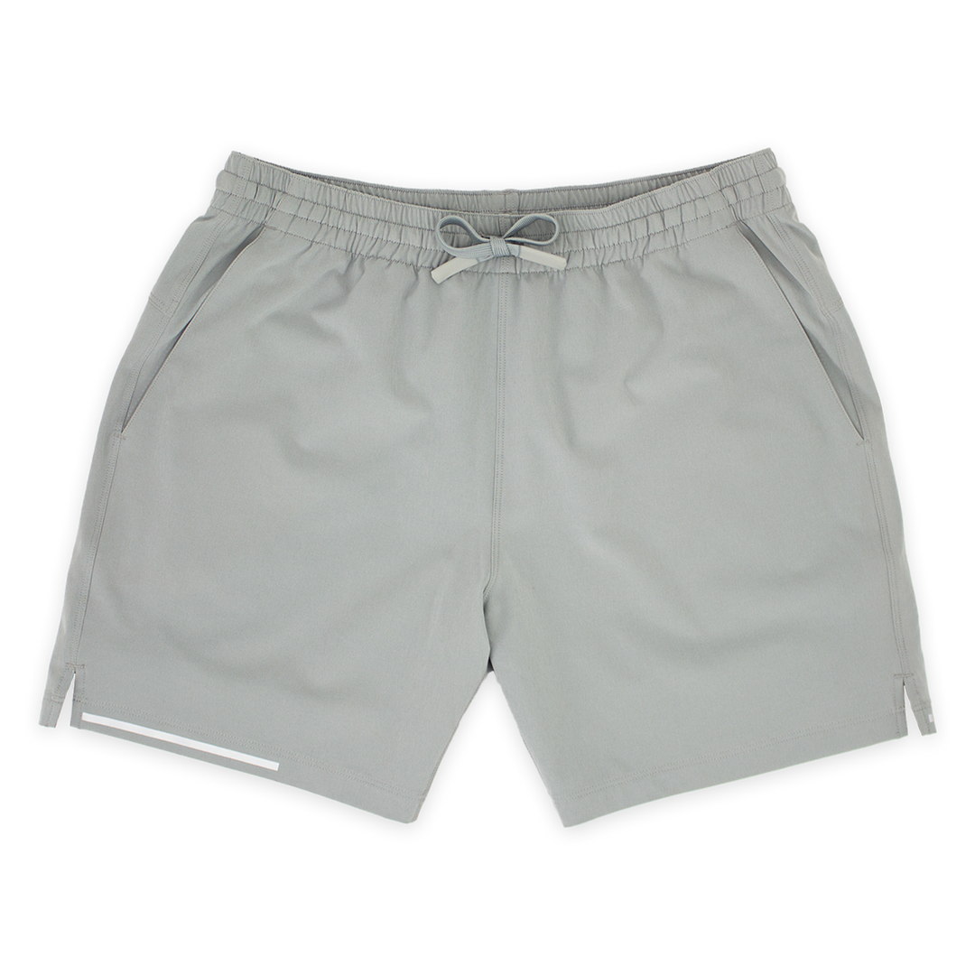 Run Short 5.5" Grey front with elastic waistband, dyed-to-match drawstring with rubberized tips, two front pockets, split hem, and reflective line on bottom right hem
