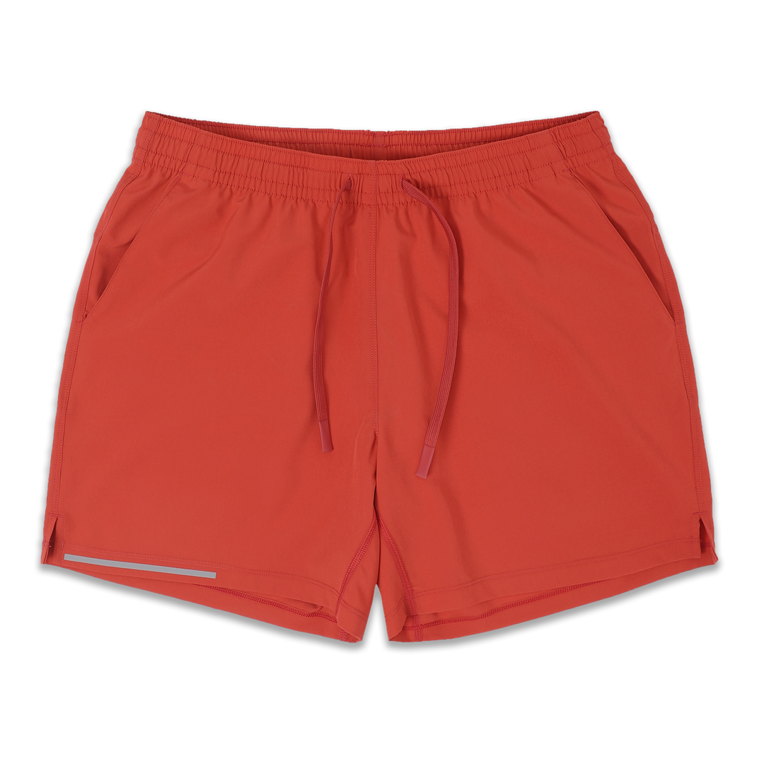 Run Short 5.5" Coral front with elastic waistband, dyed-to-match drawstring with rubberized tips, two front pockets, split hem, and reflective line on bottom right hem