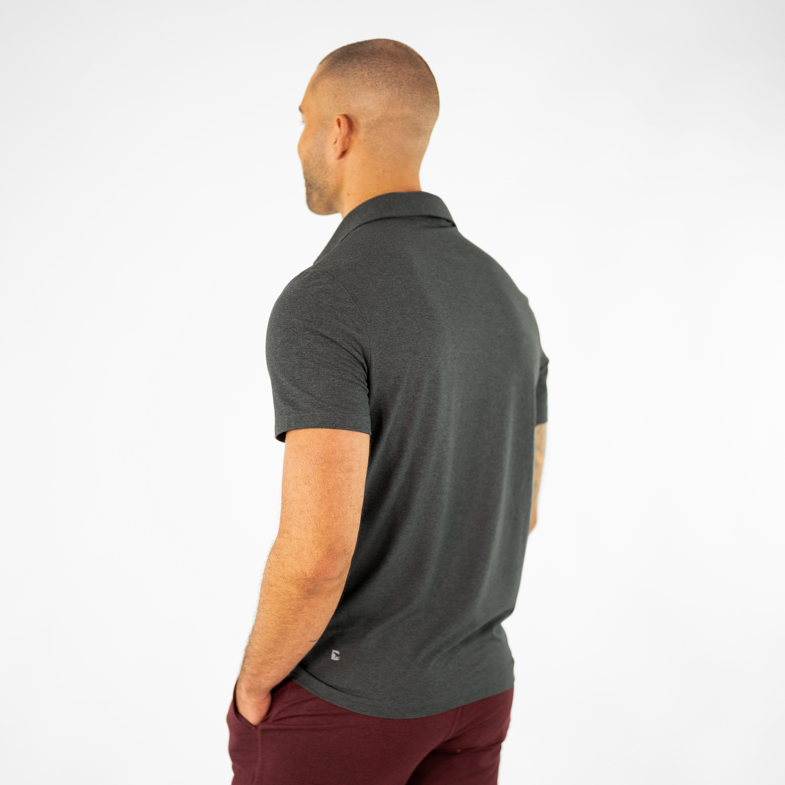 Tech Polo Charcoal on model paired with Tech Short Maroon