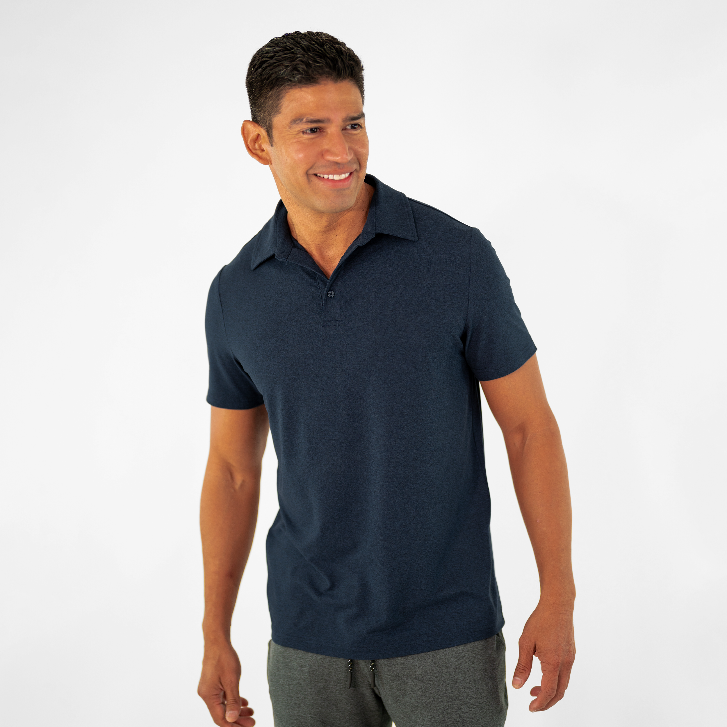 Tech Polo Navy on model paired with Tech Short Charcoal