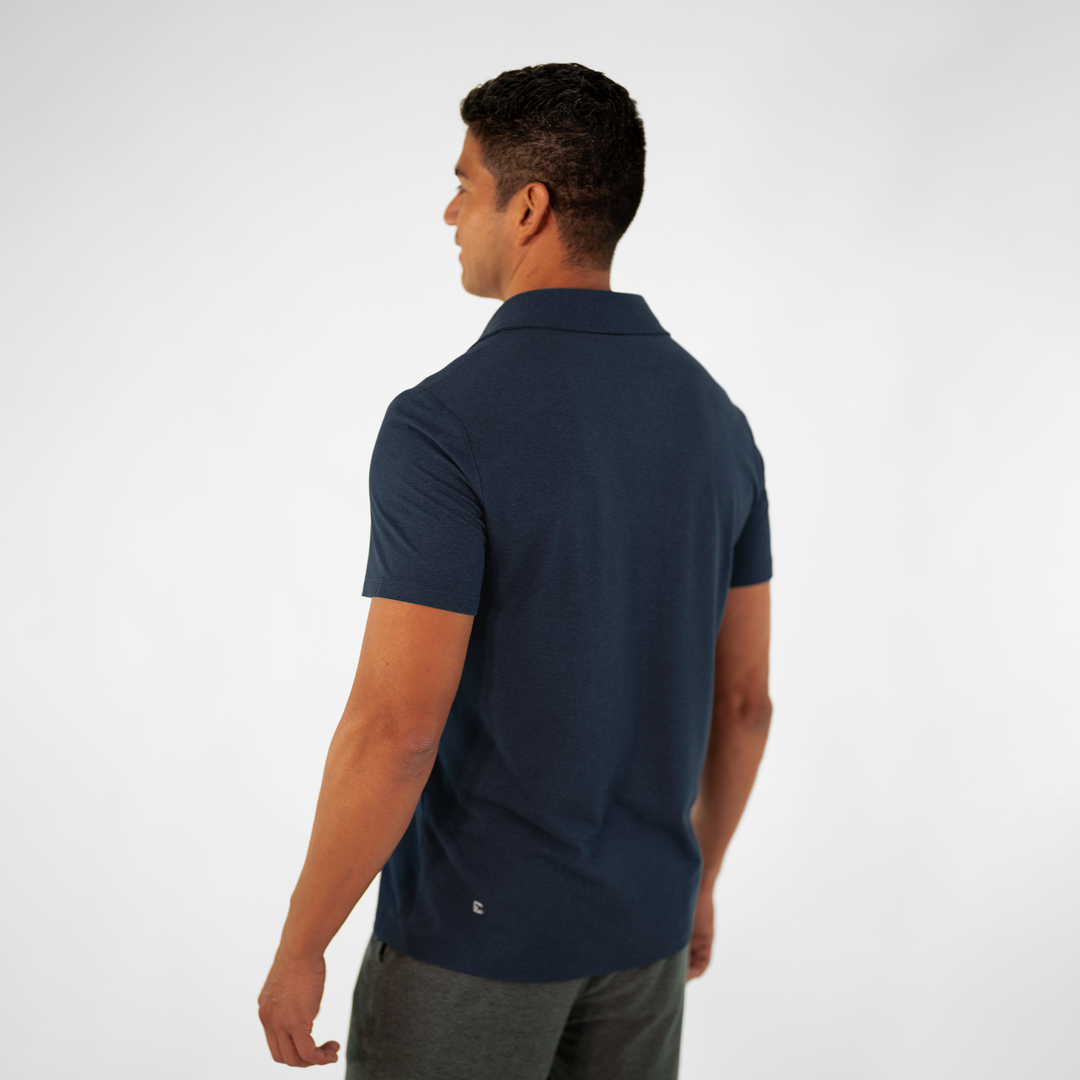 Tech Polo Navy on model paired with Tech Short Charcoal